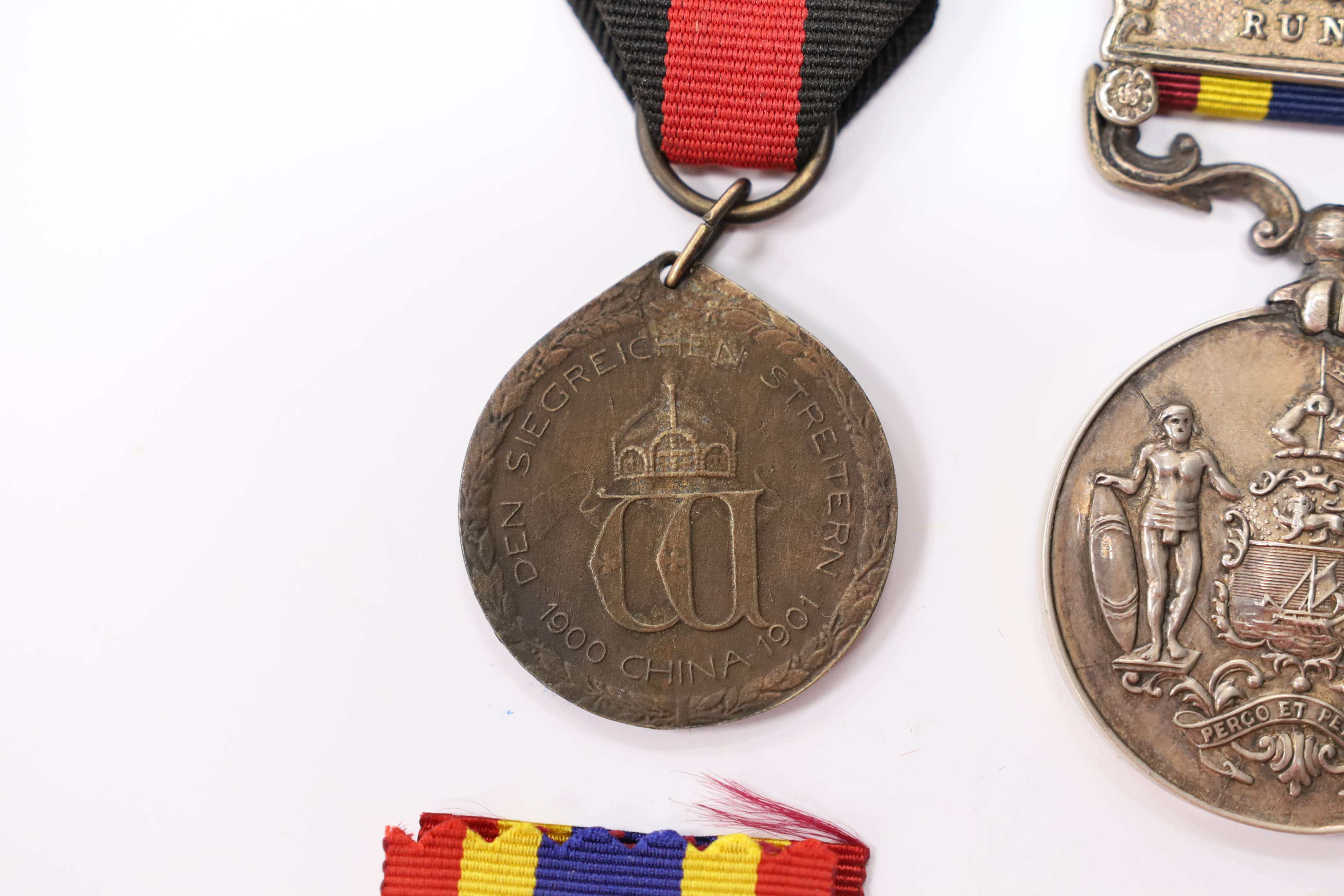 Assorted medals; two replica British North Borneo medals; Balaklava medallion; bronze GV medal; German China Campaign medal; bronze NRA medallion, unnamed